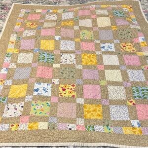 Charming Patchwork Quilt with Floral Accents